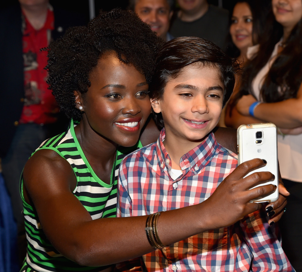 ANAHEIM, CA - AUGUST 15: Actors Lupita Nyong'o (L) and Neel Sethi of THE JUNGLE BOOK took part today in "Worlds, Galaxies, and Universes: Live Action at The Walt Disney Studios" presentation at Disney's D23 EXPO 2015 in Anaheim, Calif.  (Photo by Alberto E. Rodriguez/Getty Images for Disney) *** Local Caption *** Lupita Nyong'o; Neel Sethi