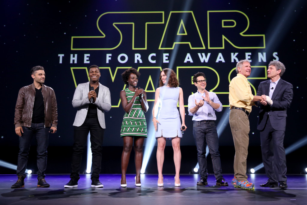 ANAHEIM, CA - AUGUST 15:  (L-R) Actors Oscar Isaac, John Boyega, Lupita Nyong'o, Daisy Ridley, director J.J. Abrams and actor Harrison Ford of STAR WARS: THE FORCE AWAKENS and Chairman of the Walt Disney Studios Alan Horn took part today in "Worlds, Galaxies, and Universes: Live Action at The Walt Disney Studios" presentation at Disney's D23 EXPO 2015 in Anaheim, Calif.  (Photo by Jesse Grant/Getty Images for Disney) *** Local Caption *** Oscar Isaac; John Boyega; Lupita Nyong'o; Daisy Ridley; J.J. Abrams; Harrison Ford; Alan Horn